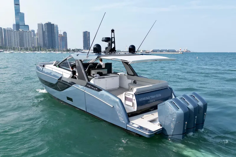  Yacht Photos Pics 2024 Azimut Verve 48 yacht cruising near city skyline on a sunny day.