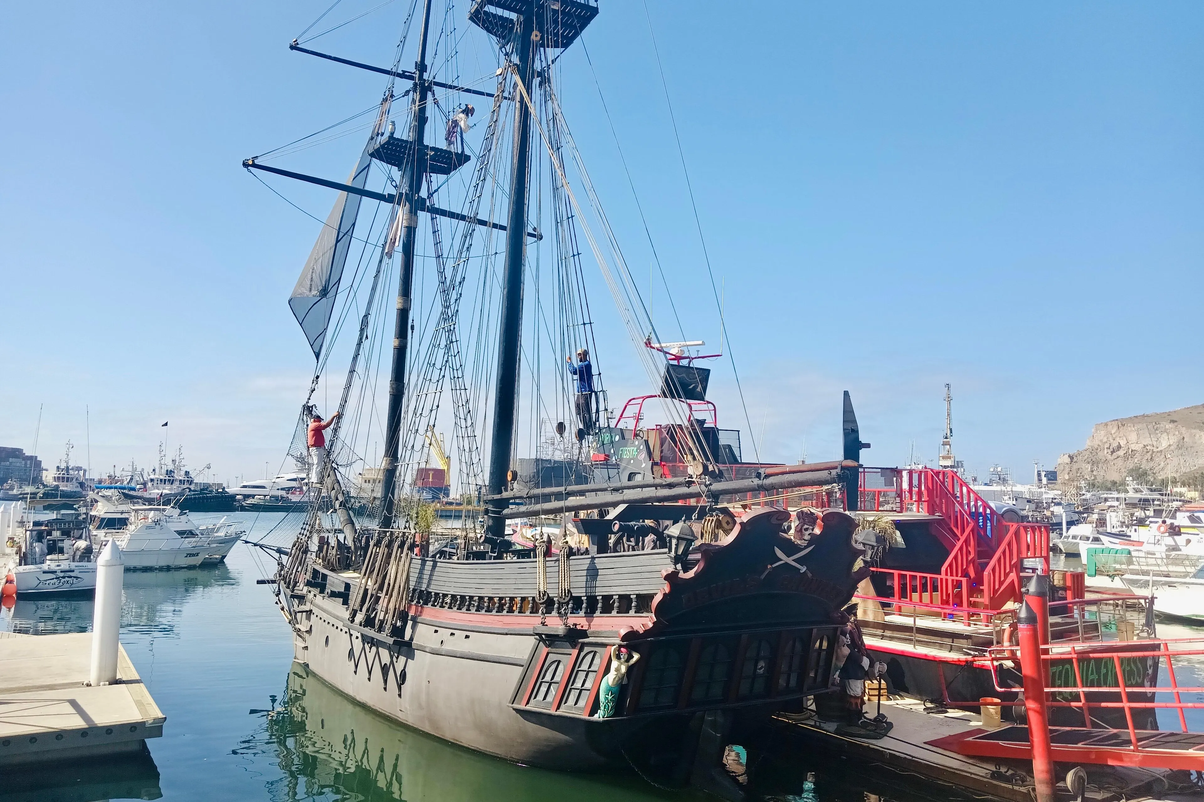Custom 1977 Brigantine ship docked in a marina, with crew members on deck.