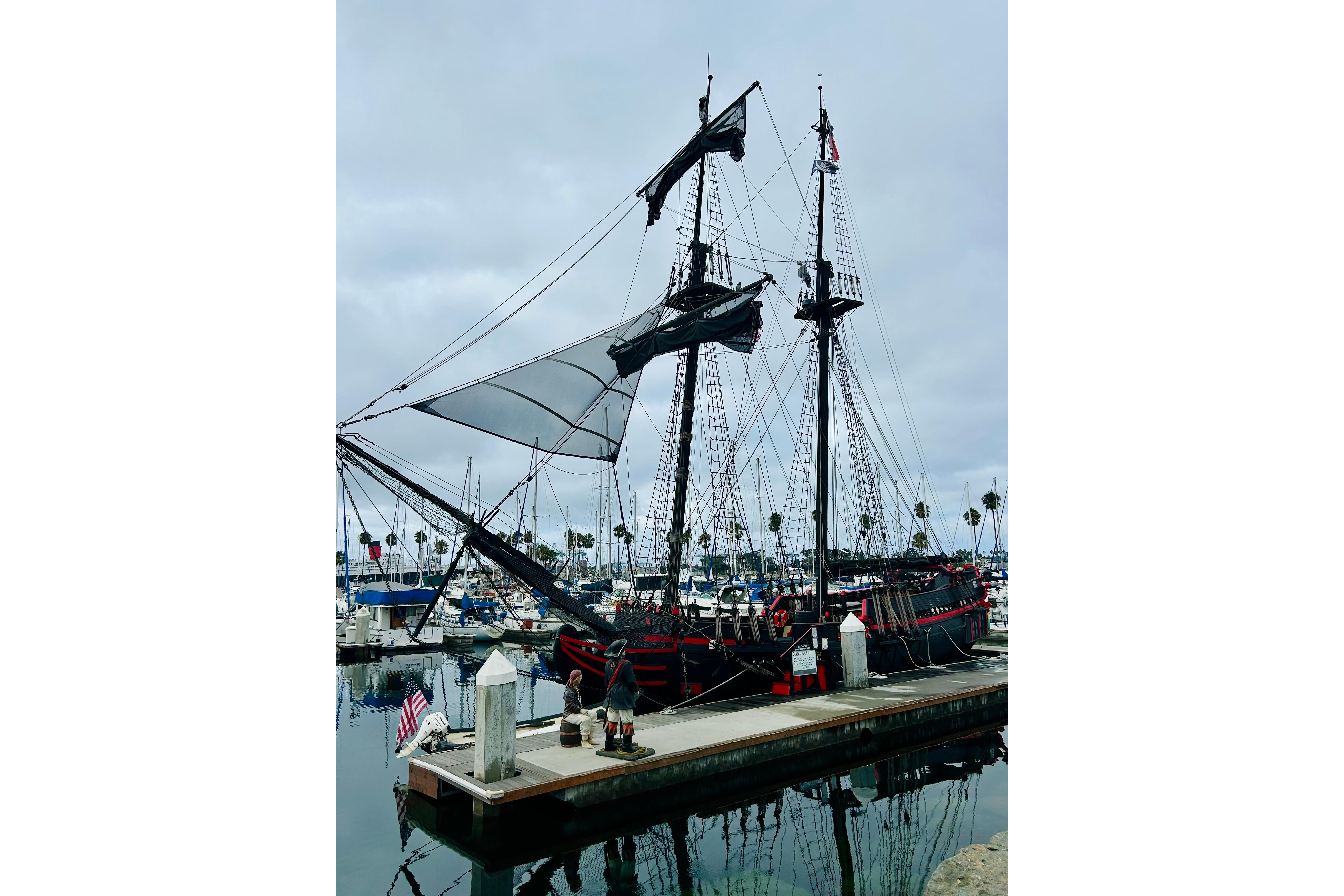 Vintage 1977 Custom Brigantine ship docked at a marina with overcast skies.