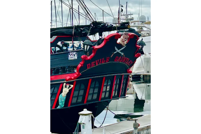 Devil's Gauntlet Yacht Photos Pics Vintage 1977 Custom Brigantine ship "Devil's Gauntlet" docked, featuring pirate-themed decor.