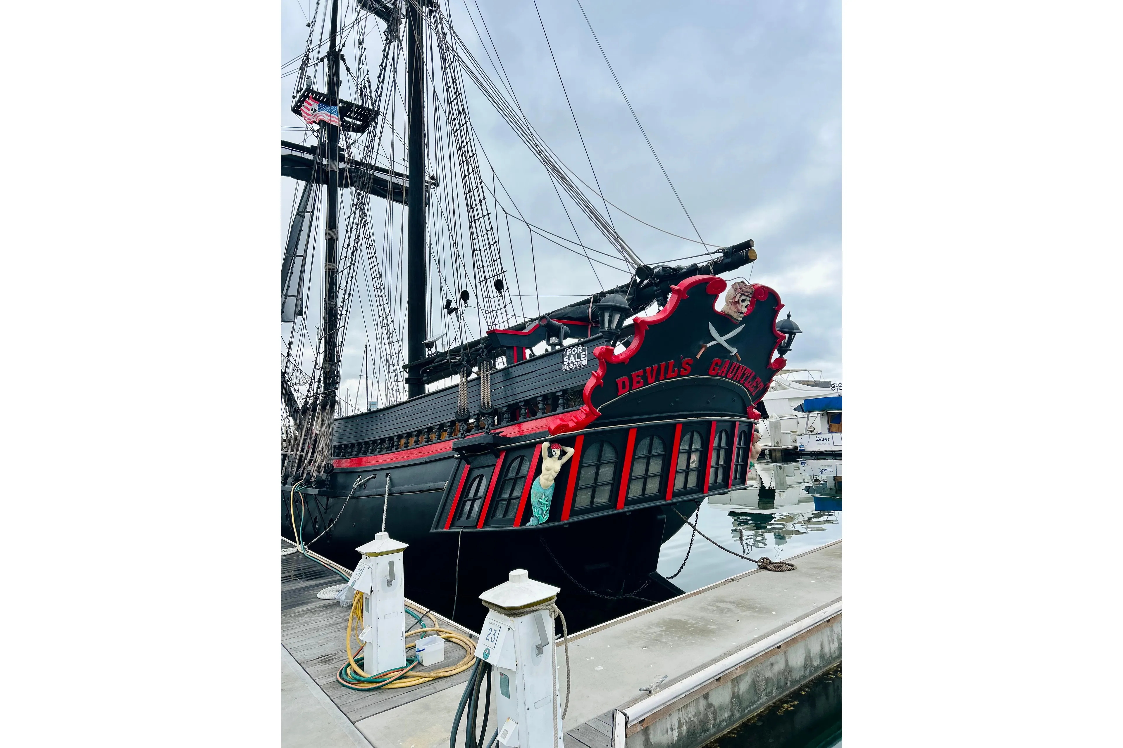 Vintage 1977 Custom Brigantine ship "Devil's Gauntlet" docked at marina, featuring pirate-themed design.