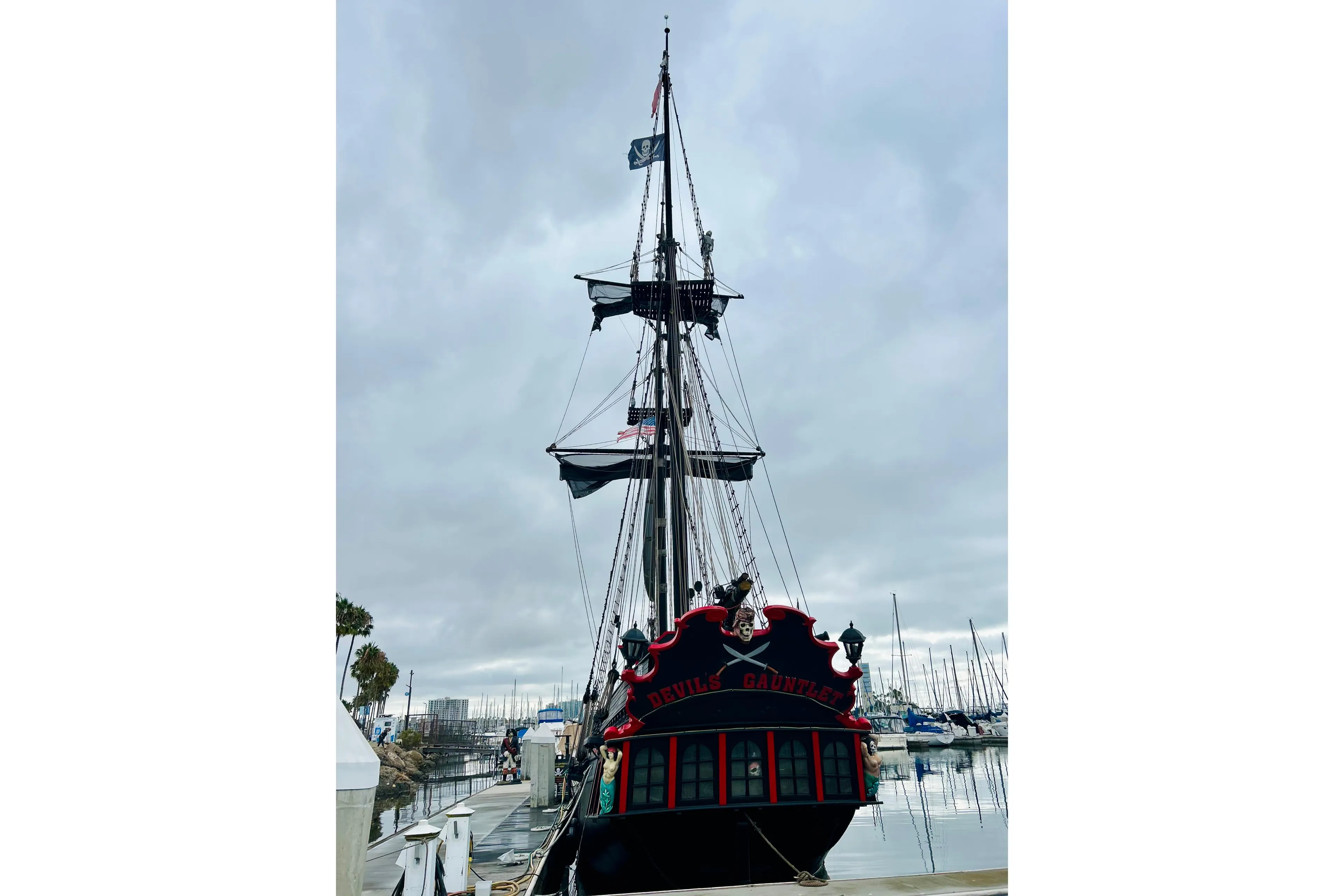 Vintage 1977 Custom Brigantine ship docked, featuring pirate-themed decor and flags.