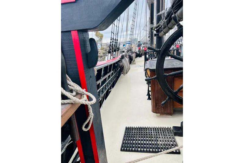 Devil's Gauntlet Yacht Photos Pics 1977 Custom Brigantine ship deck with ropes and steering wheel, showcasing nautical details.