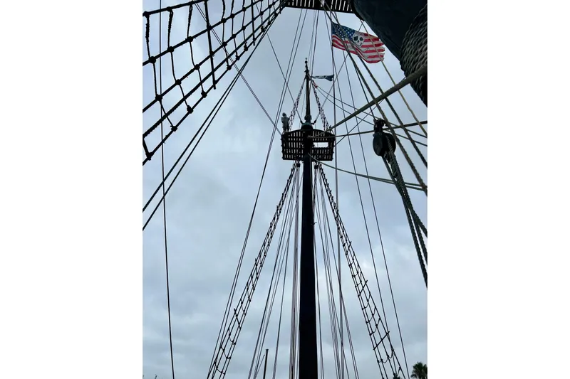 Devil's Gauntlet Yacht Photos Pics Tall ship mast with rigging and American flag, Custom Brigantine, 1977.