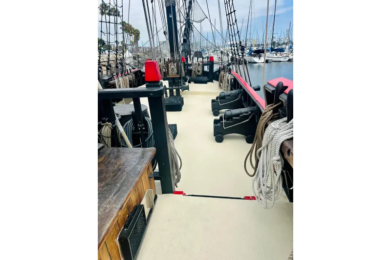 Devil's Gauntlet Yacht Photos Pics Deck view of a 1977 Custom Brigantine ship with ropes and cannons.