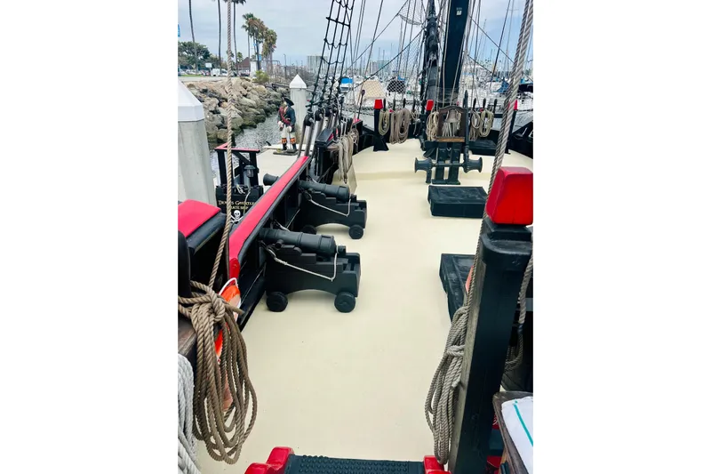 Devil's Gauntlet Yacht Photos Pics Deck view of a 1977 Custom Brigantine ship with ropes and cannons.