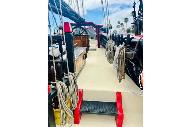 Devil's Gauntlet Yacht Photos Pics Deck view of a 1977 Custom Brigantine ship with ropes and red accents.