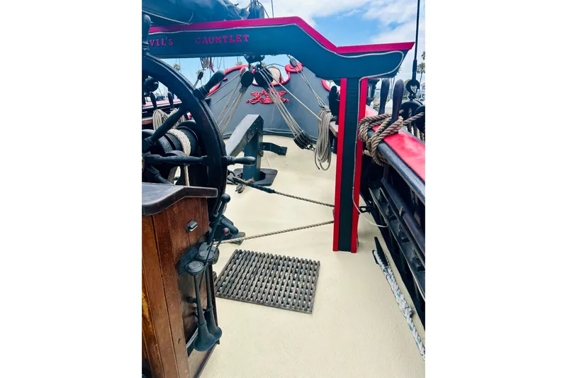 Devil's Gauntlet Yacht Photos Pics Vintage 1977 Custom Brigantine ship deck with wooden wheel and nautical ropes.