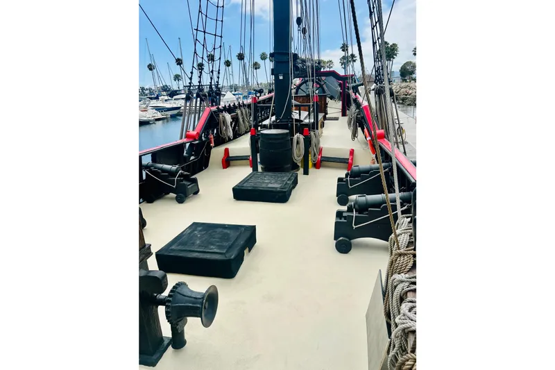 Devil's Gauntlet Yacht Photos Pics 1977 Custom Brigantine ship deck with cannons, ropes, and marina view.