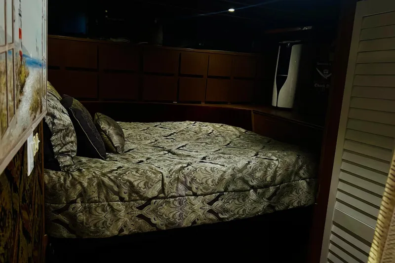 Devil's Gauntlet Yacht Photos Pics Cozy bedroom interior on a 1977 Custom Brigantine boat with patterned bedding.