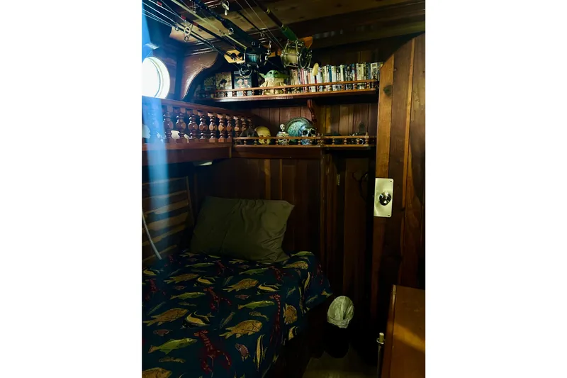 Devil's Gauntlet Yacht Photos Pics Cozy wooden cabin interior on a 1977 Custom Brigantine, featuring a bed and nautical decor.