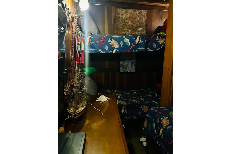 Devil's Gauntlet Yacht Photos Pics Cozy 1977 Custom Brigantine cabin with nautical-themed bunk beds and model ship decor.