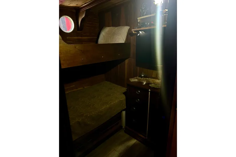 Devil's Gauntlet Yacht Photos Pics Cozy wooden cabin interior with bunk beds on a 1977 Custom Brigantine.