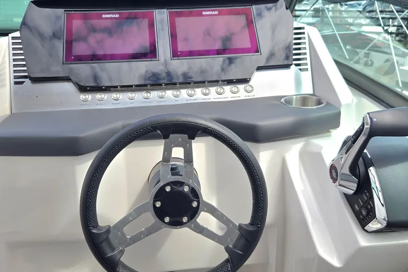 Ventura Yacht Photos Pics Steering console of 2025 Ventura Daycruicer with dual Simrad displays and modern controls.