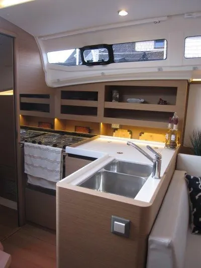  Yacht Photos Pics Modern kitchen area in 2024 Jeanneau 380 sailboat with sink and stove.