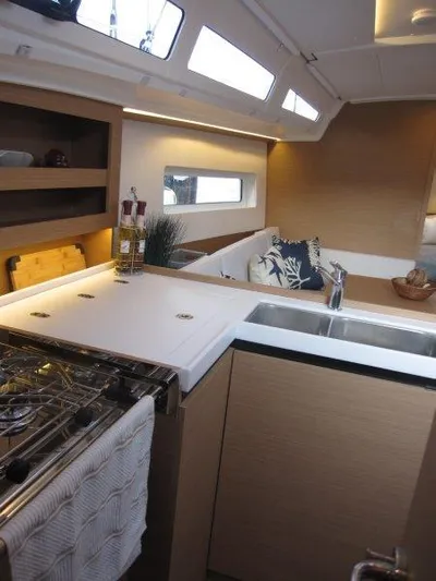  Yacht Photos Pics Modern kitchen area in 2024 Jeanneau 380 sailboat with sleek design.