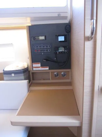  Yacht Photos Pics Navigation station of 2024 Jeanneau 380 sailboat with control panel and storage.