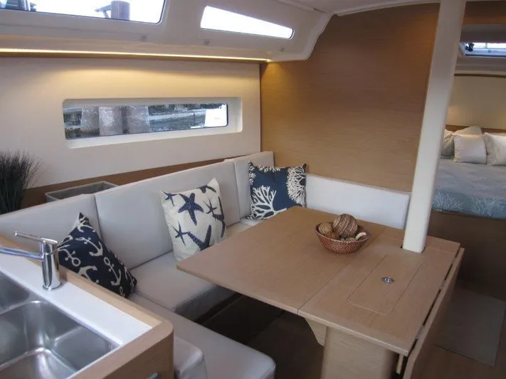  Yacht Photos Pics Interior of 2024 Jeanneau 380 sailboat with dining area and modern decor.