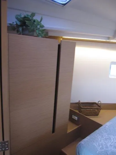  Yacht Photos Pics Interior of 2024 Jeanneau 380 sailboat with wooden cabinetry and cozy decor.
