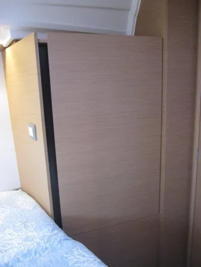  Yacht Photos Pics Interior cabin of 2024 Jeanneau 380 sailboat with wooden paneling.