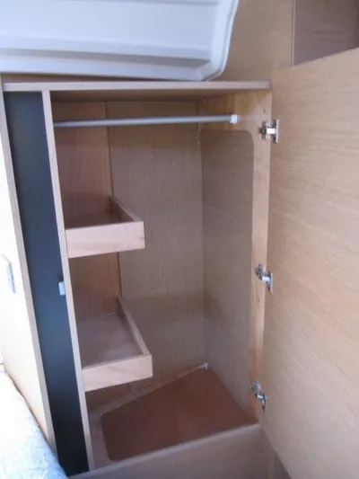 Yacht Photos Pics 2024 Jeanneau 380 yacht interior closet with shelves and hanging rod.