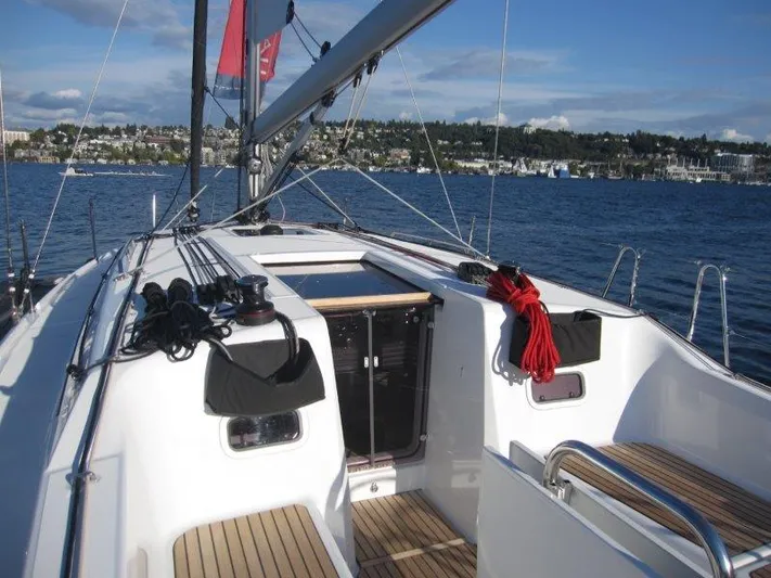  Yacht Photos Pics 2024 Jeanneau 380 sailboat deck with scenic waterfront view.