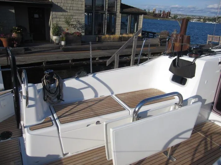  Yacht Photos Pics 2024 Jeanneau 380 sailboat cockpit with teak flooring, docked by waterfront.