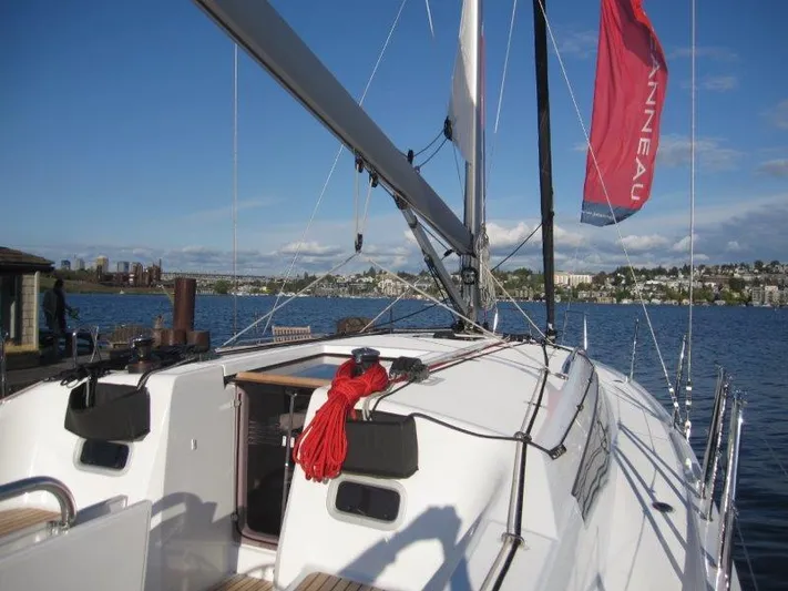  Yacht Photos Pics 2024 Jeanneau 380 sailboat on a sunny day, docked by the waterfront.