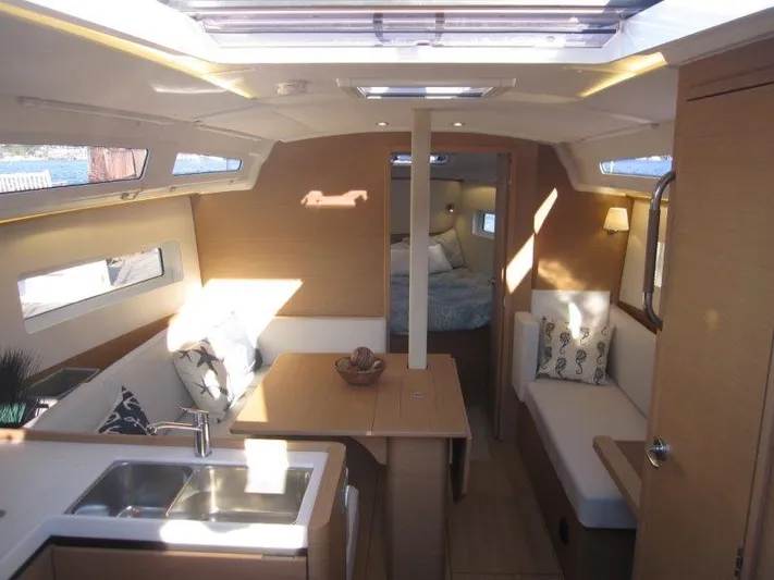  Yacht Photos Pics Interior of 2024 Jeanneau 380 sailboat with modern kitchen and cozy seating area.