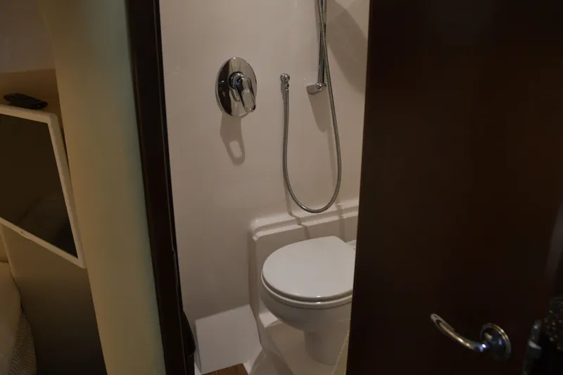  Yacht Photos Pics Bathroom interior of 2013 Regal 42 Sport Coupe yacht, featuring a compact shower and toilet.