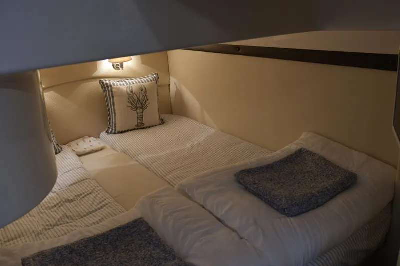  Yacht Photos Pics Cozy cabin interior of 2013 Regal 42 Sport Coupe with twin beds and nautical decor.