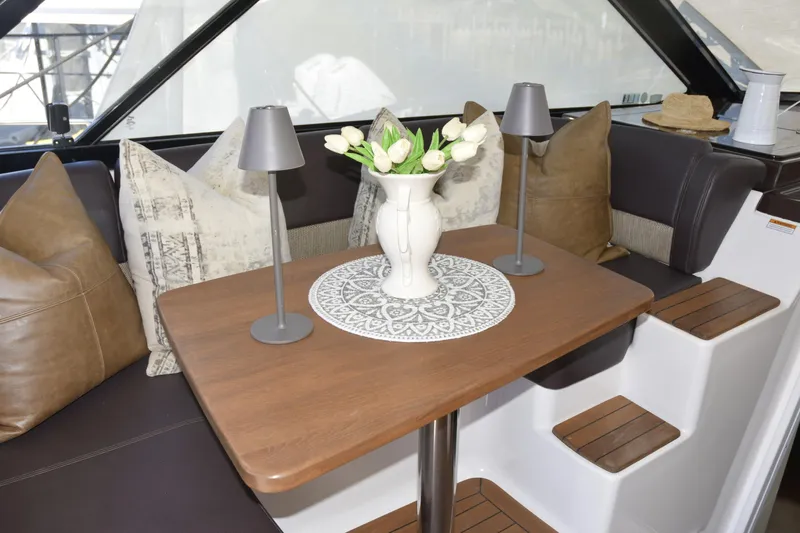  Yacht Photos Pics Interior of 2013 Regal 42 Sport Coupe with elegant table, flowers, and cozy seating.