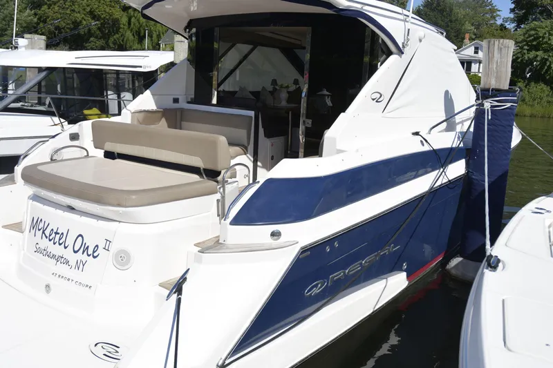  Yacht Photos Pics 2013 Regal 42 Sport Coupe yacht docked, featuring sleek design and comfortable seating.