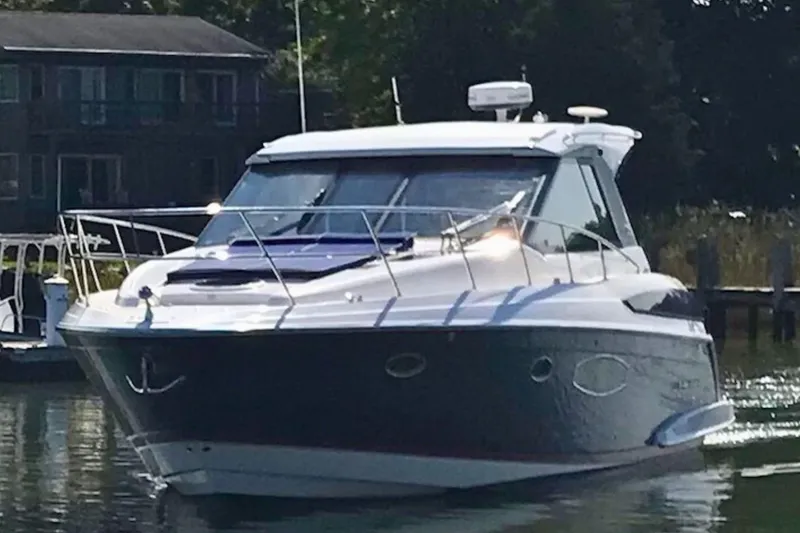  Yacht Photos Pics 2013 Regal 42 Sport Coupe yacht docked in a serene marina setting.