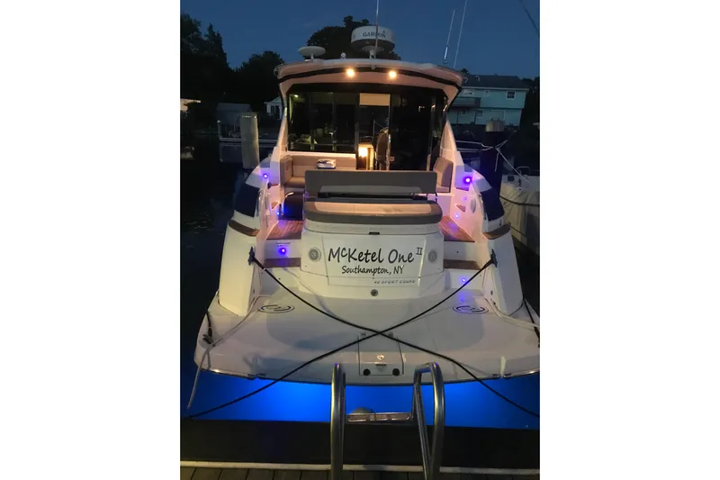  Yacht Photos Pics 2013 Regal 42 Sport Coupe yacht docked at night with blue underwater lights.