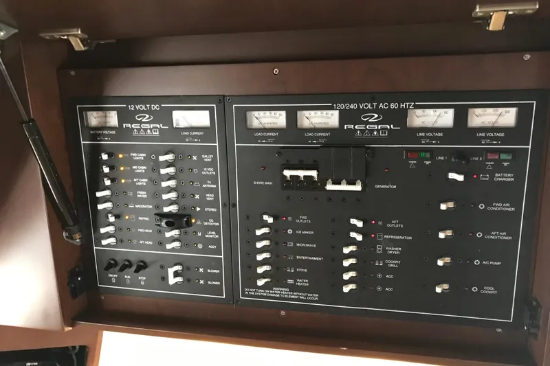  Yacht Photos Pics Control panel of a 2013 Regal 42 Sport Coupe boat, featuring various switches and gauges.