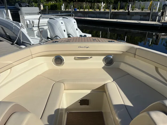  Yacht Photos Pics 2025 Chris-Craft Calypso 28 boat interior with beige seating and docked engines.