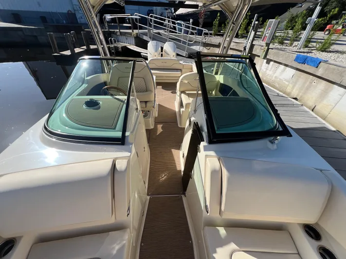  Yacht Photos Pics 2025 Chris-Craft Calypso 28 boat interior with open windshield and seating area.