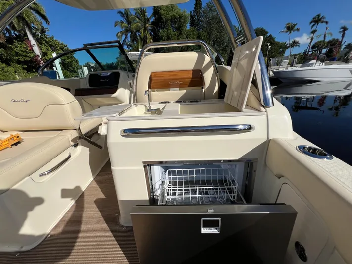  Yacht Photos Pics 2025 Chris-Craft Calypso 28 interior with open fridge, luxurious seating, and sleek design.