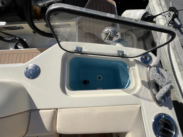  Yacht Photos Pics 2025 Chris-Craft Calypso 28 boat interior with open storage compartment and seating.