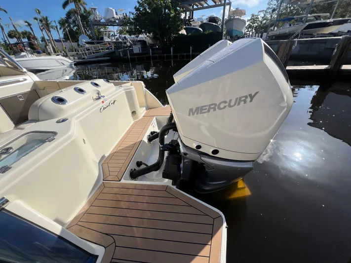  Yacht Photos Pics 2025 Chris-Craft Calypso 28 with Mercury outboard engine, docked in a marina.