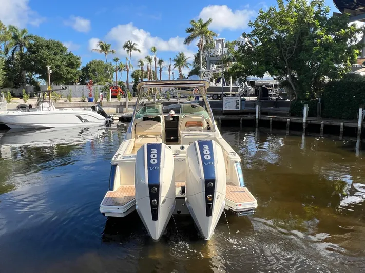  Yacht Photos Pics 2025 Chris-Craft Calypso 28 boat docked, featuring dual 300 V8 engines, surrounded by palm trees.