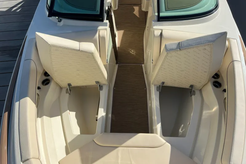  Yacht Photos Pics 2025 Chris-Craft Calypso 28 boat interior with open storage compartments and cushioned seating.