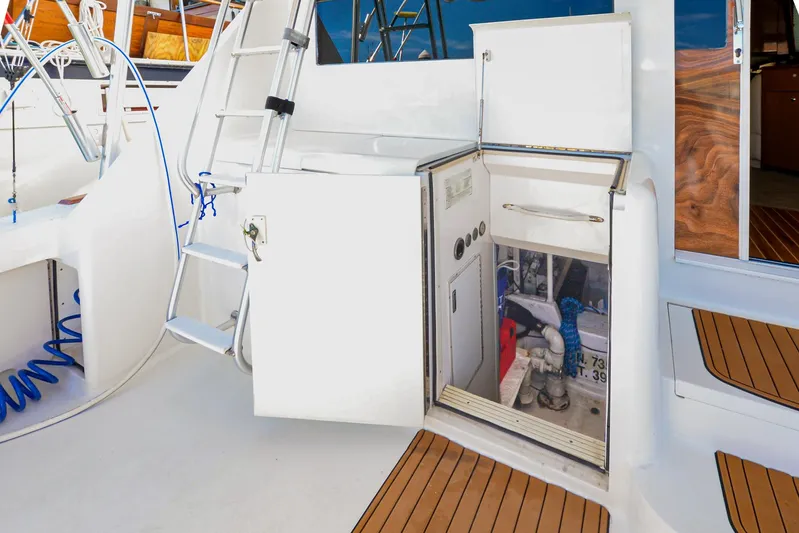 Sue-sea Yacht Photos Pics 1999 Viking 55 Convertible yacht deck with open storage compartment and ladder.