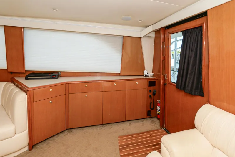 Sue-sea Yacht Photos Pics Interior of 1999 Viking 55 Convertible yacht with wooden cabinetry and beige seating.