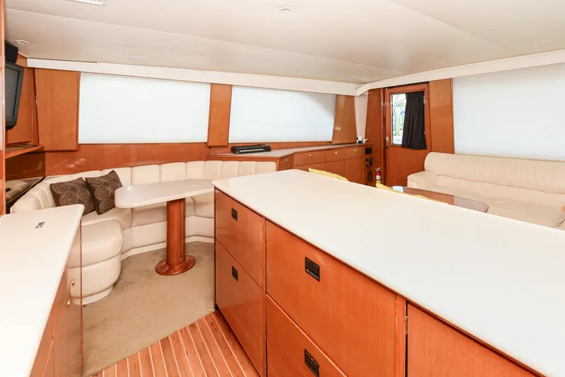 Sue-sea Yacht Photos Pics Interior of 1999 Viking 55 Convertible yacht with modern furnishings and wood accents.