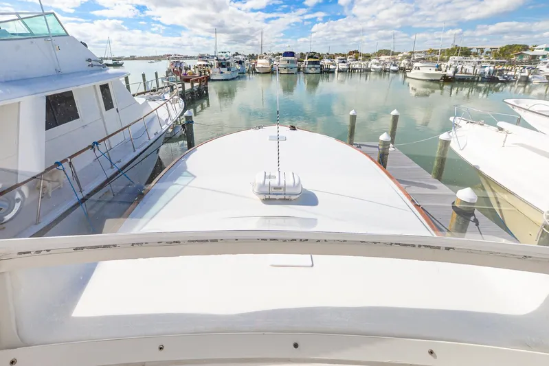 Sue-sea Yacht Photos Pics 1999 Viking 55 Convertible yacht docked in a marina, surrounded by other boats.