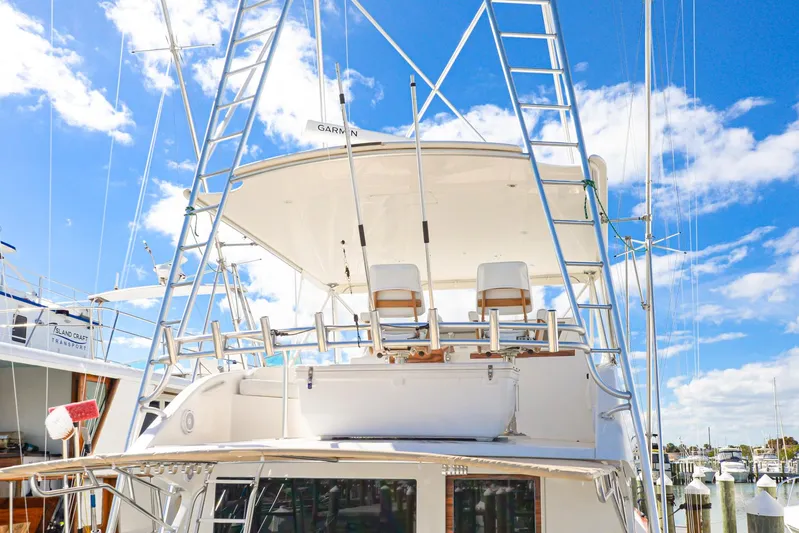 Sue-sea Yacht Photos Pics 1999 Viking 55 Convertible yacht with tower against blue sky.