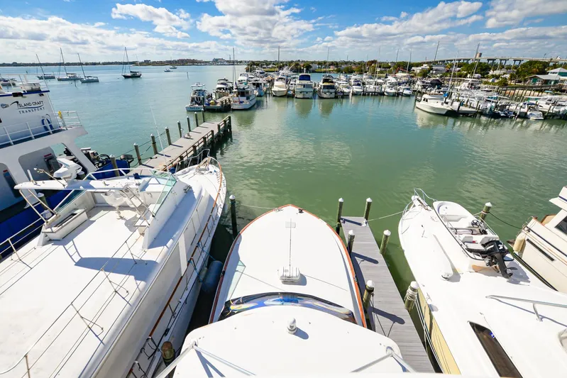 Sue-sea Yacht Photos Pics Marina view with 1999 Viking 55 Convertible yacht docked among other boats.