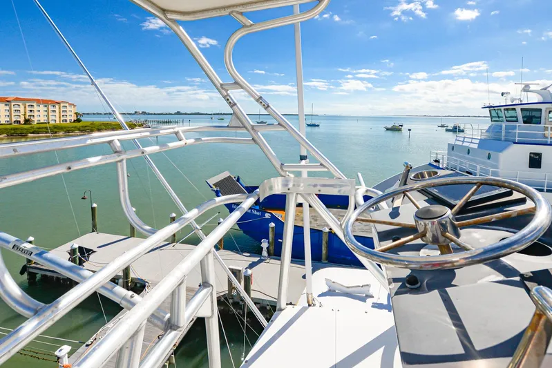 Sue-sea Yacht Photos Pics 1999 Viking 55 Convertible yacht helm with ocean view and docked boats.
